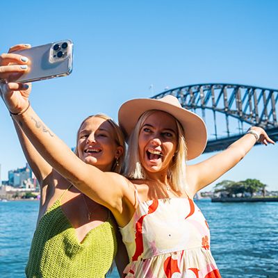 girls taking a selfie in front of Sydney Harbour Bridge