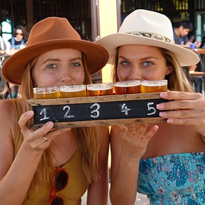 girls with a beer tasting flight at a brewery