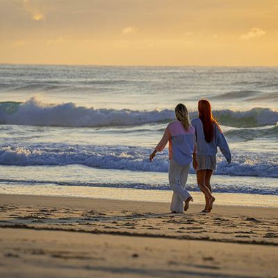 girls enjoying a leisurely morning walk on the beach