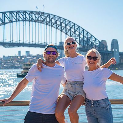 group of backpackers posting in Sydney Harbour