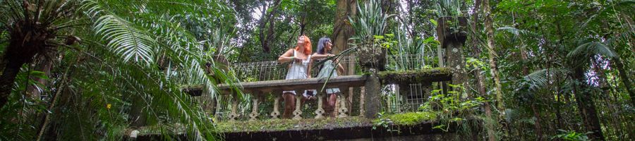 Two women standing on balcony of Paronella Park Spanish manor
