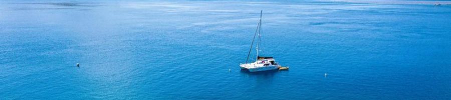 sailing catamaran cruising over blue water