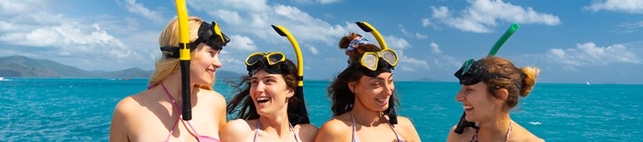 girls smiling with snorkel gear on in the whitsundays