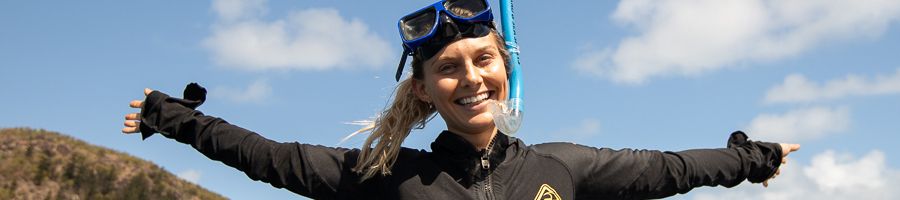 A young woman in a stinger suit in Snorkel gear