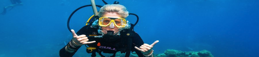 A lady scuba diving at the Great Barrier Reef