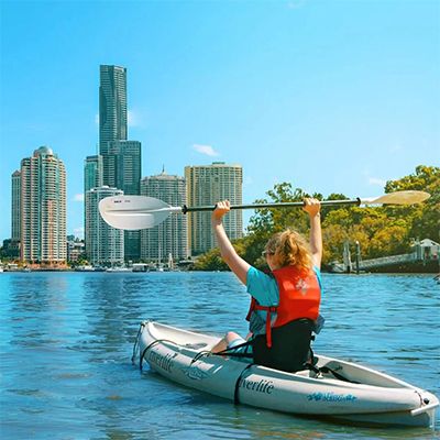 girl holding paddle while kayaking in brisbane