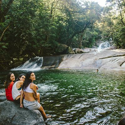 travelers sitting by the pool at josephine falls