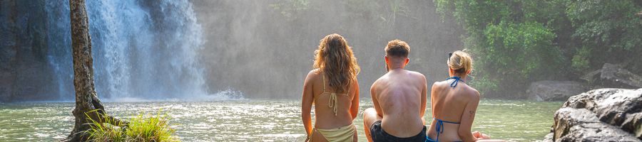 A group of three people looking at Cedar Creek Falls