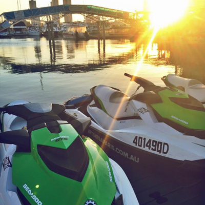 Jet ski's lined up at marina, sunsetting behind