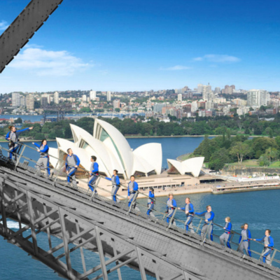 People climb the Sydney Harbour Bridge side view