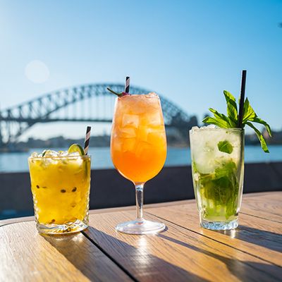 cocktails sitting on a table near sydney harbour bridge