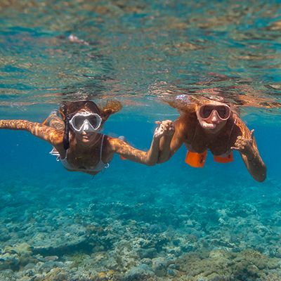 girls snorkelling underwater in queensland