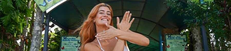 A woman posing in front of the Australian Butterfly Sanctuary