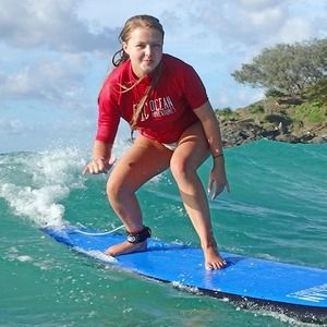 A woman surfing near Noosa