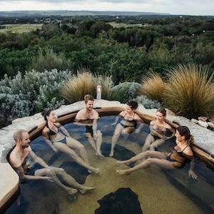 A group of people chilling in the hilltop pool