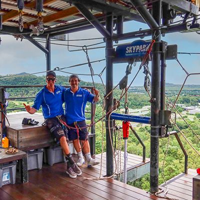 two staff at skypark cairns smiling on the bungy tower