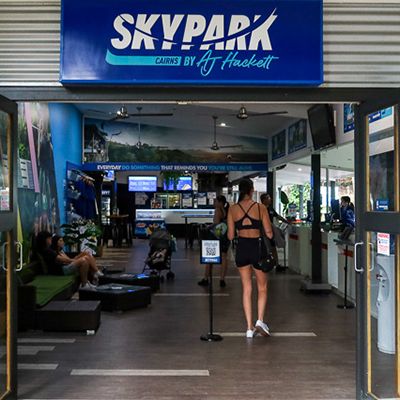 girl walking into skypark cairns aj hackett office