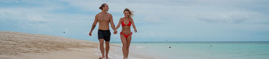couple walking on michaelmas cay sand near cairns