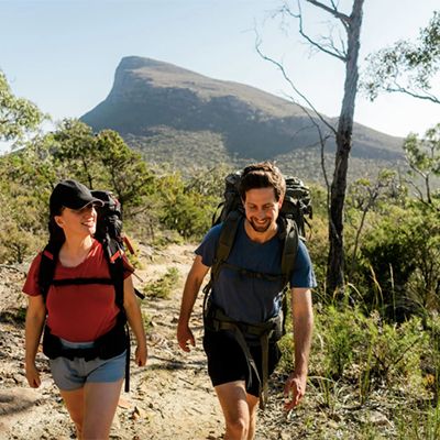 couple hiking along a grampians wilderness trail