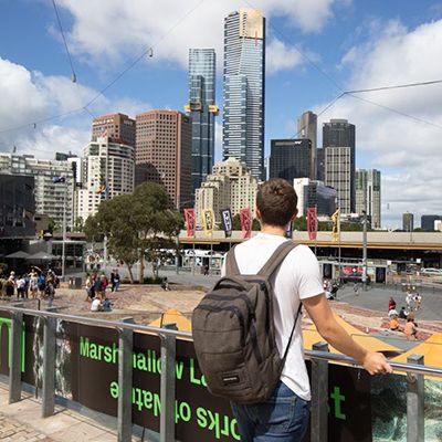 man looking out at melbourne skyline in the city