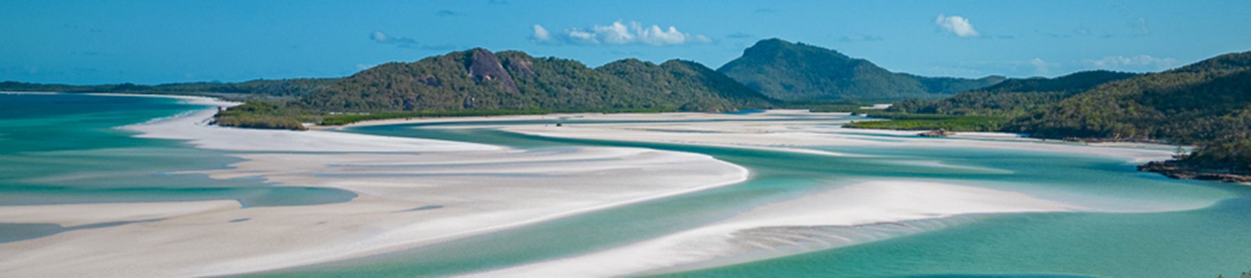 Whistunday Island's Hill Inlet Lookout with mountains and swirling sands and waters