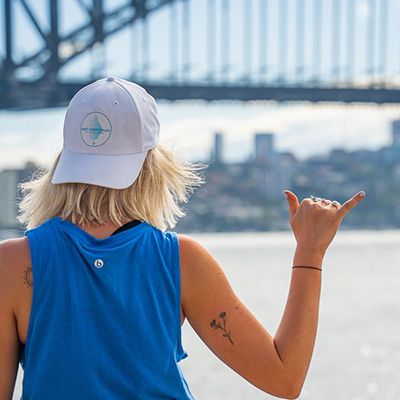 girl with east coast tours hat posing in sydney harbour