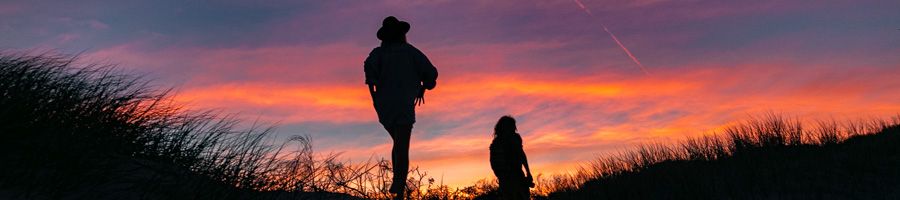 two travellers walking outside at sunset in australia