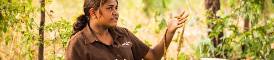 indigenous woman giving a presentation about local crafts