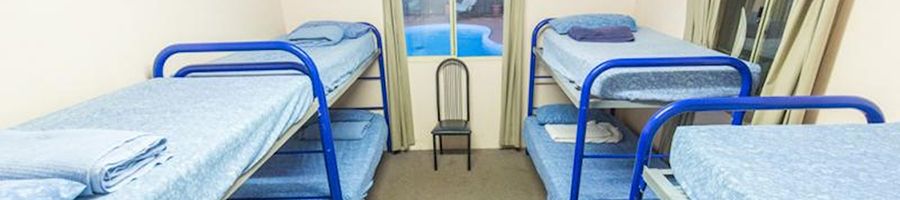 hostel bunk beds lined up in a dorm room in western australia