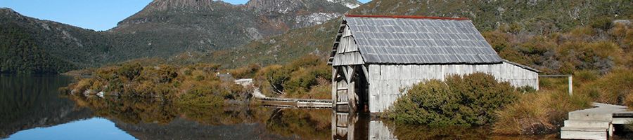 Cradle Mountain shack on Dove Lake with reflective water