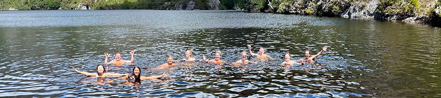 A group of people swimming in an Alpine Lake