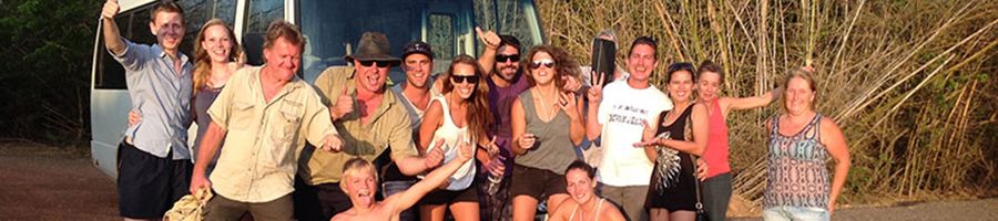 tour group gathered in front of a tour bus in litchfield national park