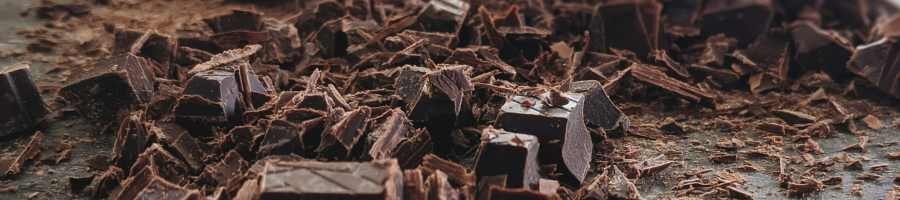 close up of chopped and shaved chocolate blocks on table