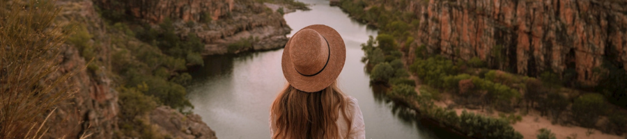 Woman in brimmed hat looking over Katherine Gorge River