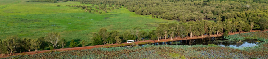 aerial view of bus driving through wetlands and floodplains