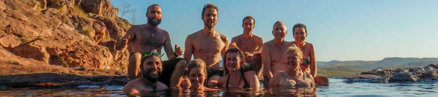 tour group relaxing in natural plunge pool outback Aus