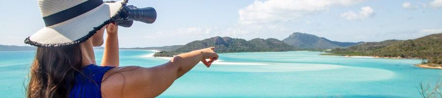 woman admiring hill inlet with binoculars