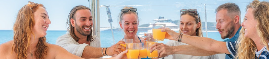 A group of people holding champagne glasses on a boat