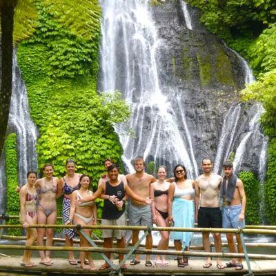 tour group standing in front of a waterfall in Bali