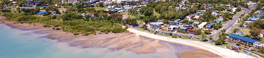 Cannonvale Beach at low tide with green trees