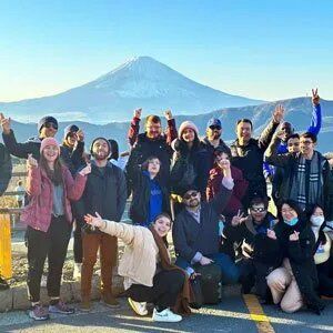 travellers posing in front of mount fuji in hakone