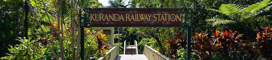 kuranda railway station sign surrounded by greenery