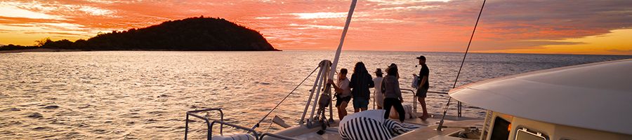 group of people watching the sunset on havanna luxury yacht whitsundays