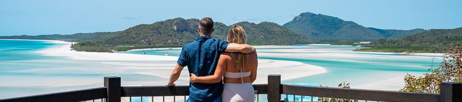 couple hugging in front of hill inlet lookout