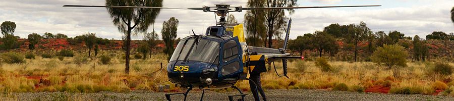 A Professional Helicopter Services helicopter setting off on a scenic flight over the Outback