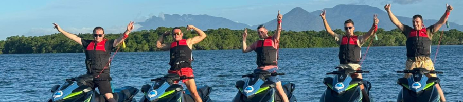 Five guys on jetski's in Cairns throwing hands in air