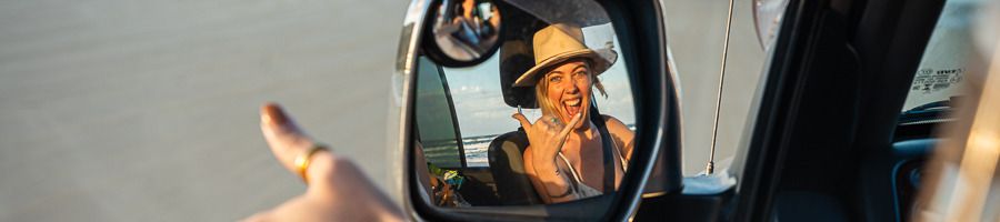 A woman in a 4WD car on the beach