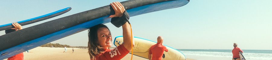 A woman holding a surfboard in Noosa