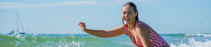 A backpacker surfing in the sea in Noosa