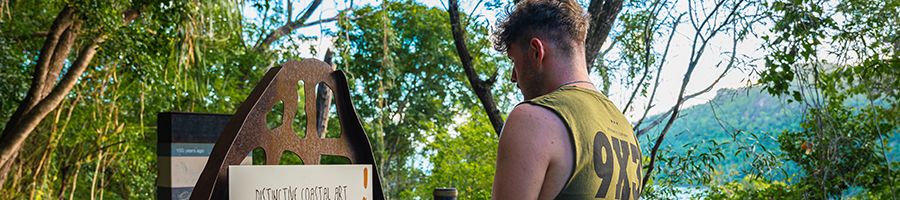 A man looking at a sign at Ngaro cultural site